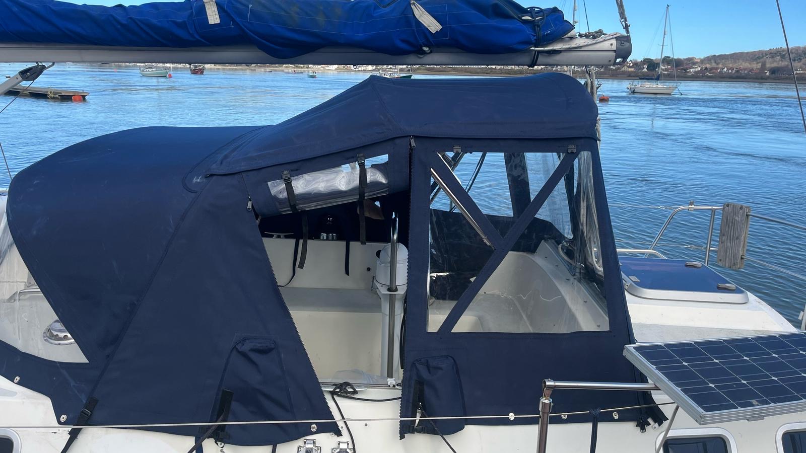 Cockpit enclosure with a detachable panel unzipped and rolled