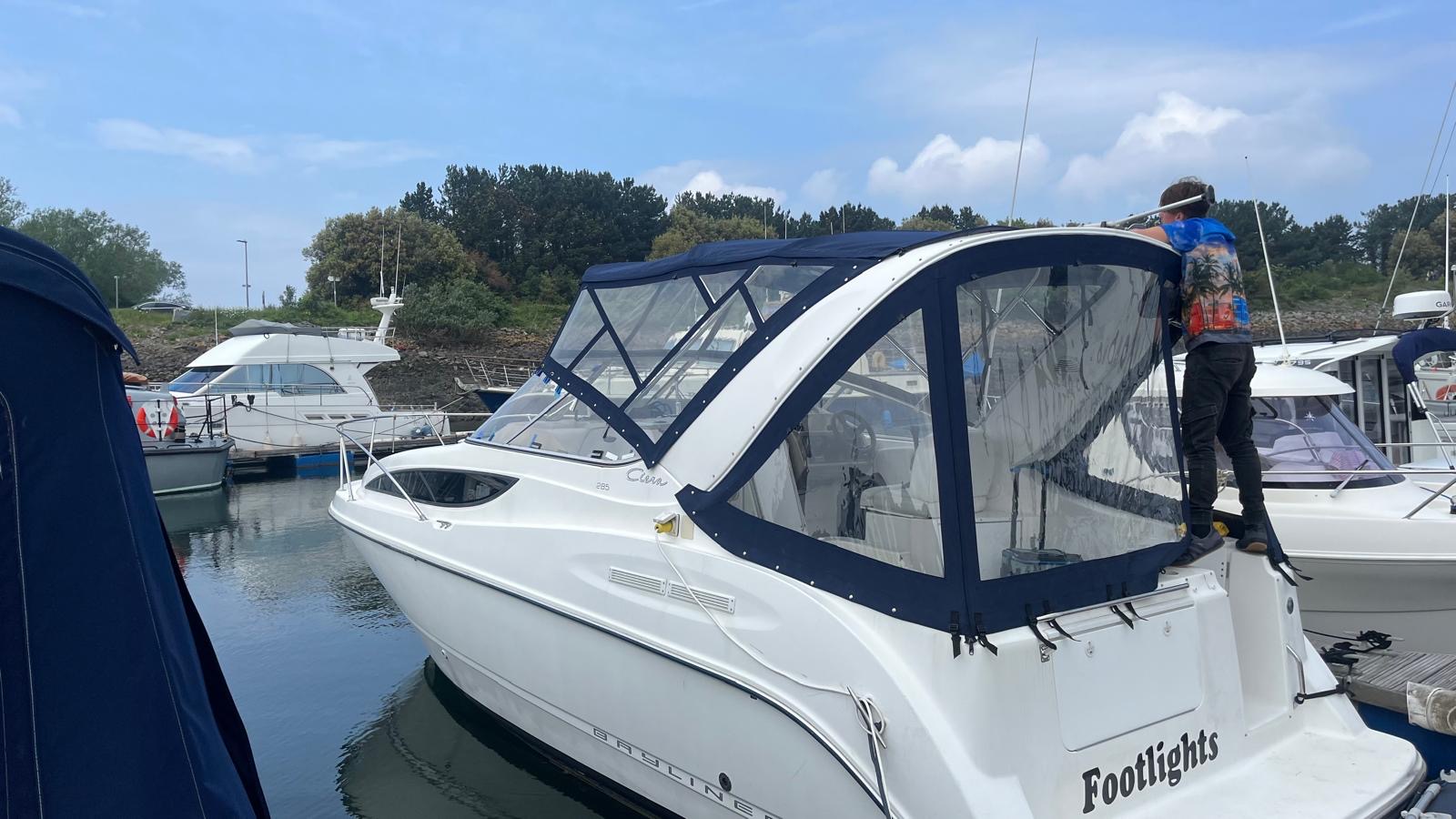 Sea Jay Marine Services fitting a bespoke navy cockpit enclosure on a motor boat