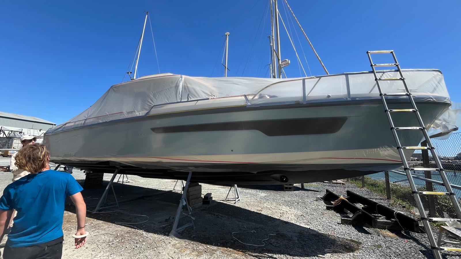 Wide side view of the large motor boat with its clear polythene template fitted, showing the full length of the project