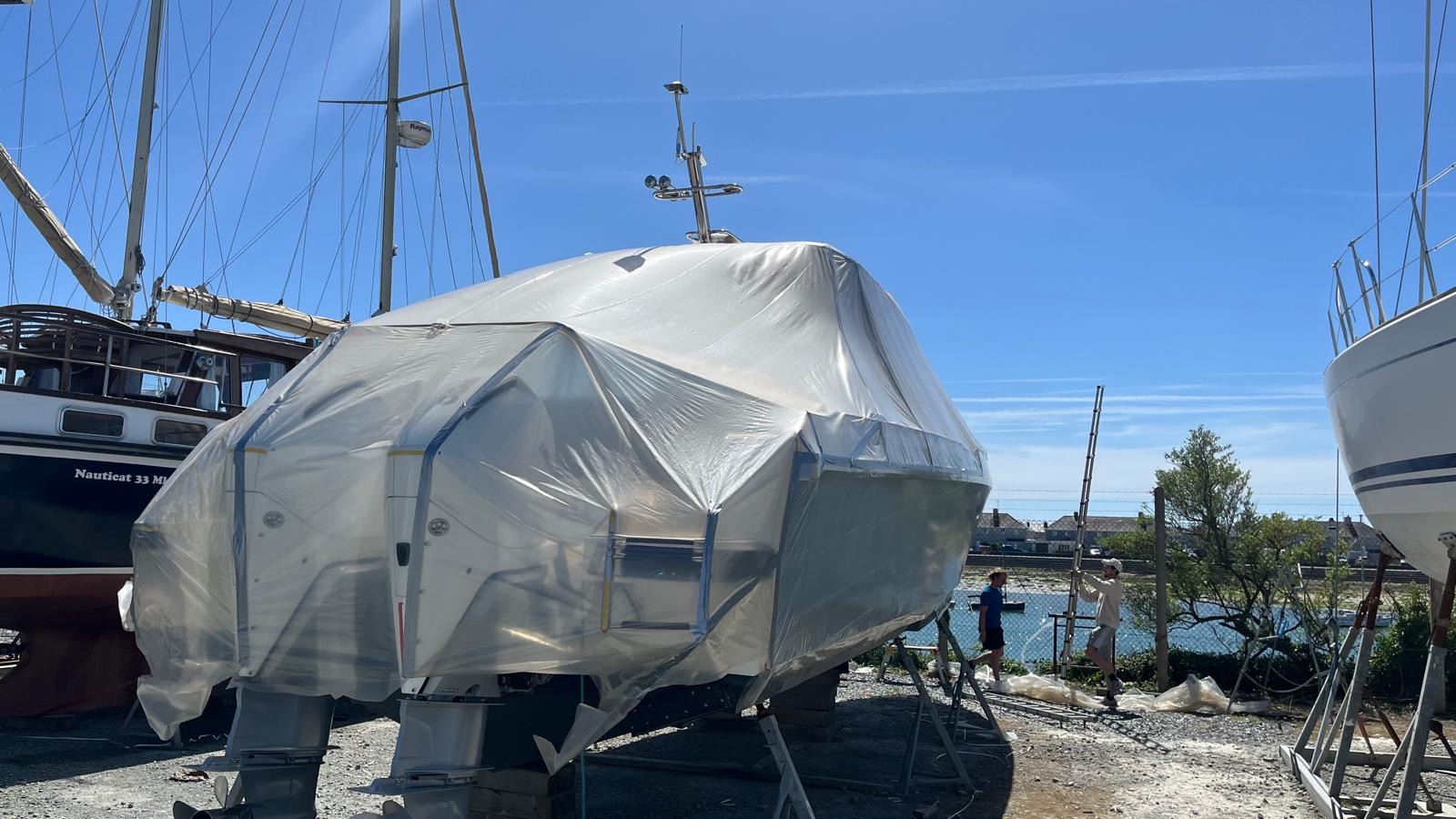 Clear polythene precision template fitted over a large motor boat