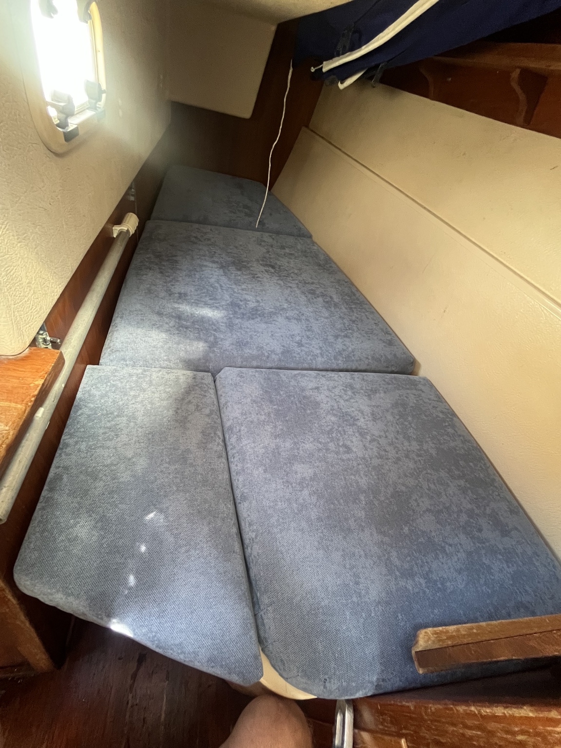 New blue berth cushions fitted in a boat cabin