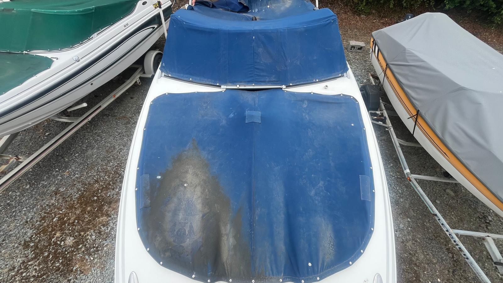 Damaged and faded blue boat cover before replacement